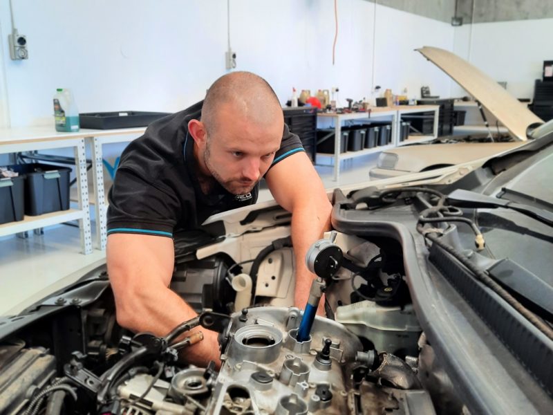 Amped AutoTech experienced mechanic working on a european car.