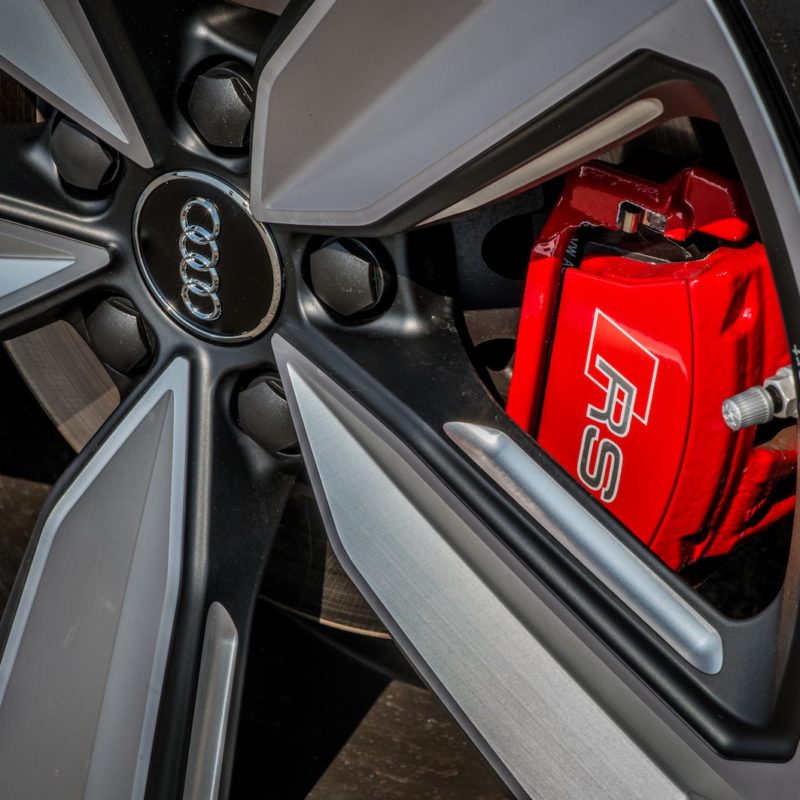 Close up of an Audi logo on a car wheel.