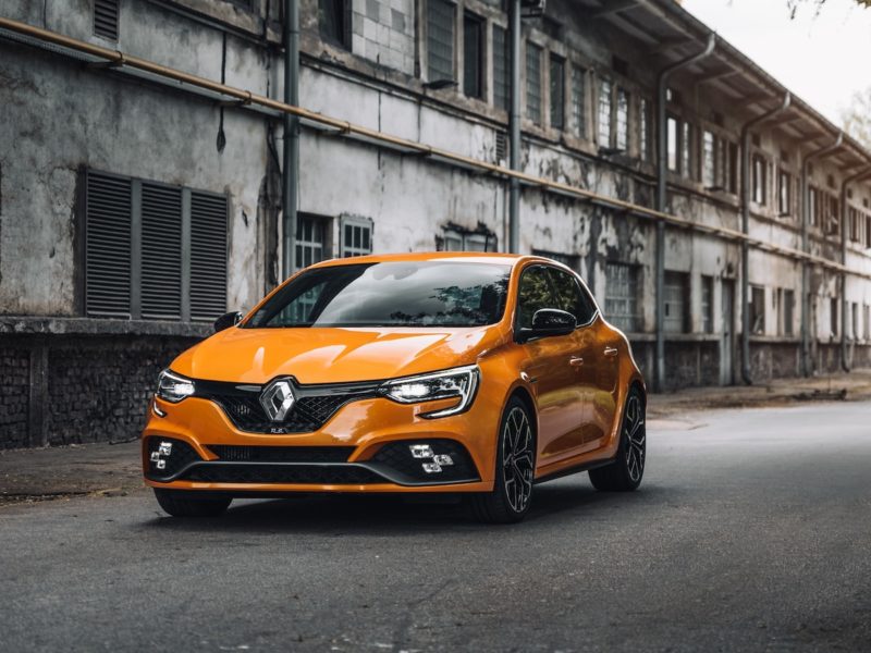 orange mercedes benz c class parked on street during daytime